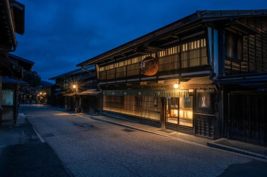 an empty street with a building at night at BYAKU Narai 