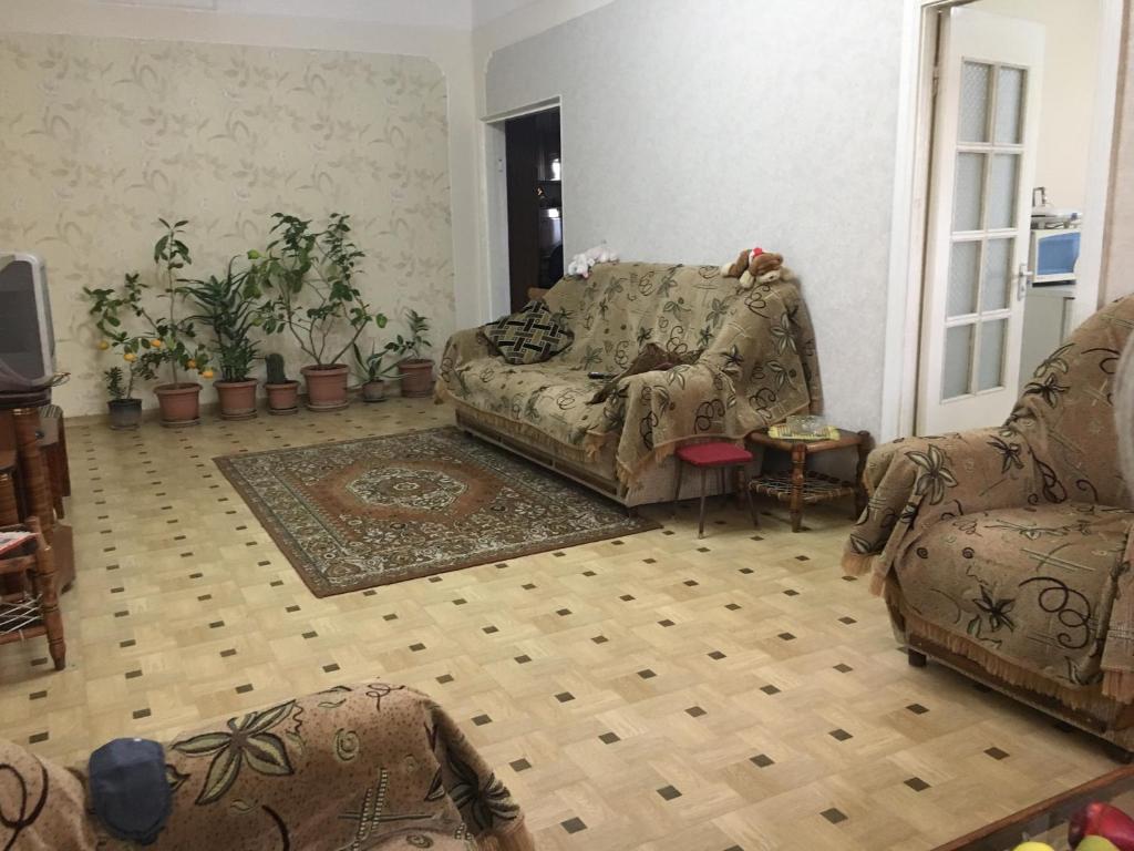 a living room with a couch and a chair at Private Guesthouse in Historic Village in Aghtsʼkʼ