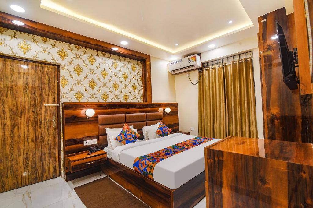 a bedroom with a bed and a television in it at FabHotel Icon in Patna