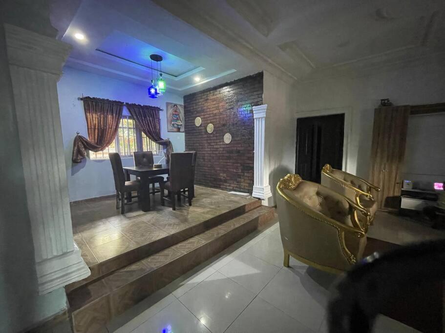 een woonkamer met een bank en een tafel bij 3-bedroom bungalow. Free parking on the premises. in Benin City