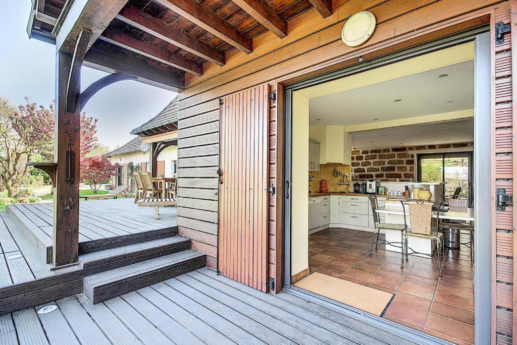 a large sliding glass door to a kitchen on a deck at Gîte de France Bayat 4 épis - Gîte de France 5 personnes 354 in Varetz