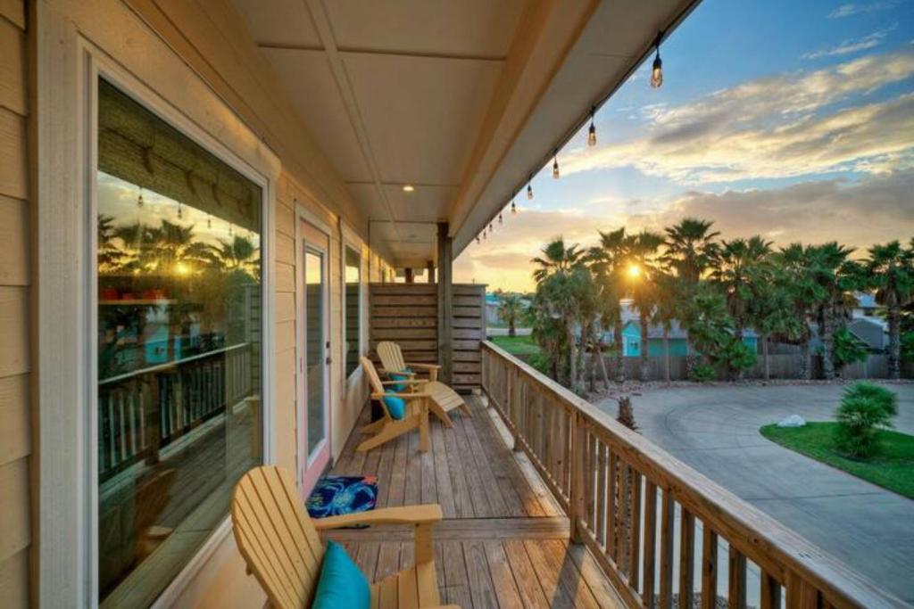 a porch with two chairs and a view of the ocean at Rock N Reel by AvantStay Old Town Location in Port Aransas