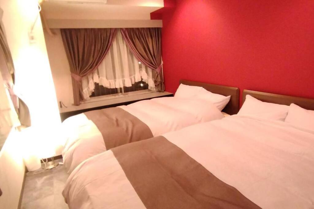 Postel nebo postele na pokoji v ubytování Nagoya Apartment Oosu