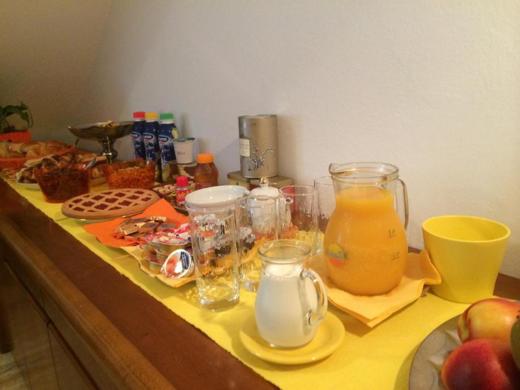 a counter topped with glasses of juice and other food at B&B Soleluna in Massa Fiscaglia