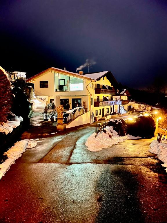 a building with a fire hydrant on a street at night at Landhaus Töchterle in Telfes im Stubai