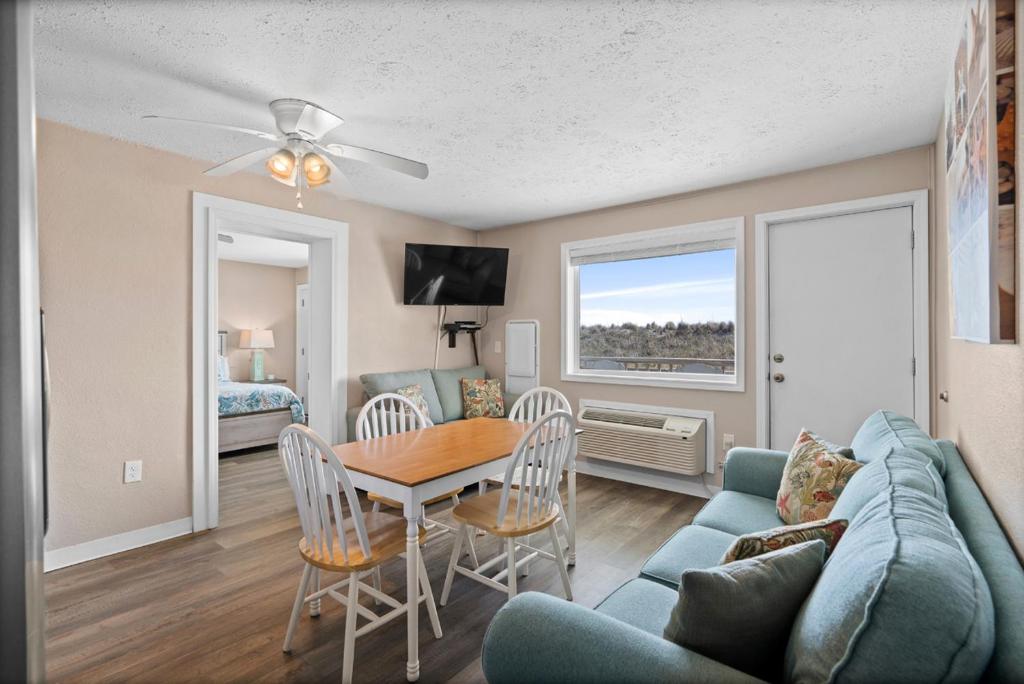 a living room with a table and a couch at Blue Mist Villas Unit 102 - Oceanfront Ground Floor Condo in Cherry Grove in Myrtle Beach