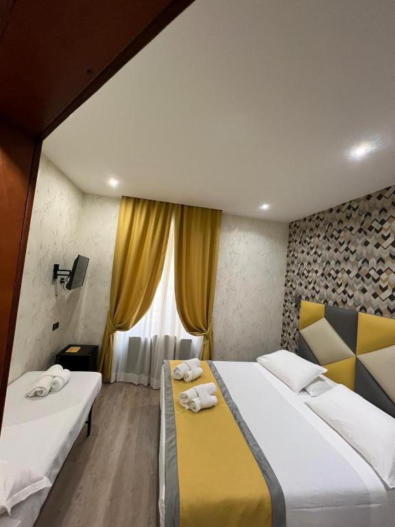 Postel nebo postele na pokoji v ubytování Hotel Ercoli House