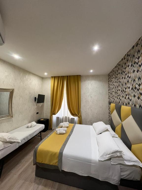 Postel nebo postele na pokoji v ubytování Hotel Ercoli House