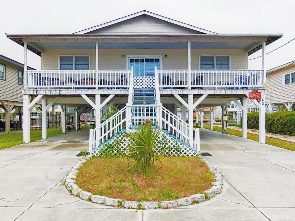 a house with a white deck and a porch at Crews Nest in Cherry Grove in Myrtle Beach