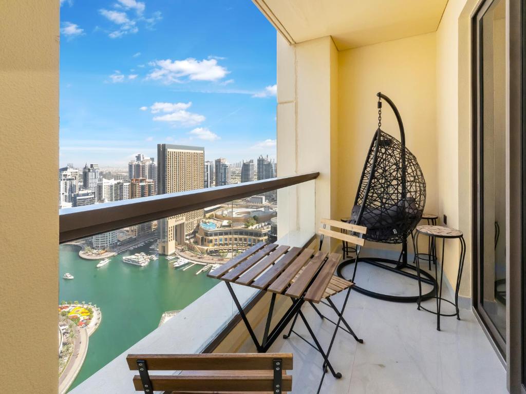 a balcony with a bench and a swing at FAM Living - Stunning 2 Bedroom Home In JBR in Dubai