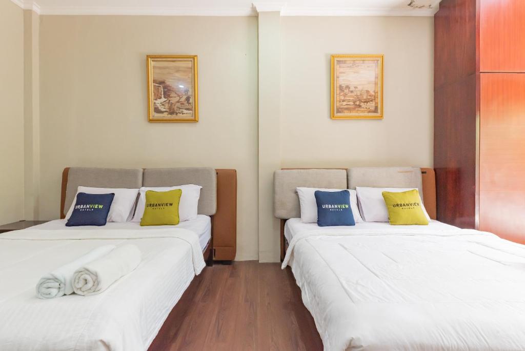 Postel nebo postele na pokoji v ubytování Urbanview Resort Botol Cisarua Puncak Bogor