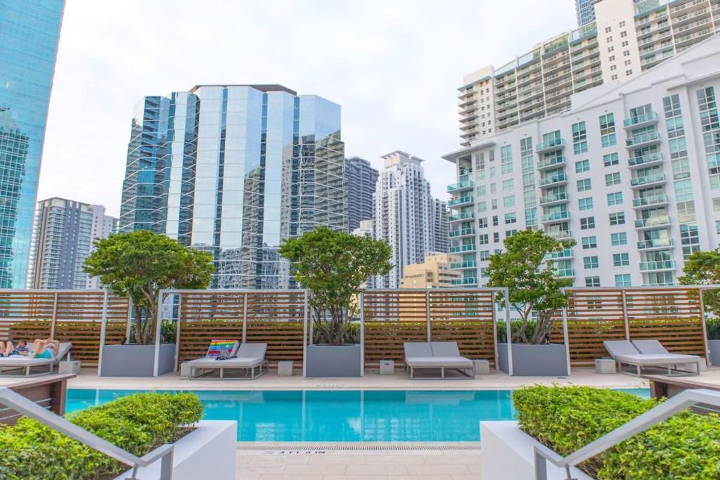 a pool in the middle of a city with tall buildings at Brickell House Dreams - Luxury Stay and Amenities in Miami