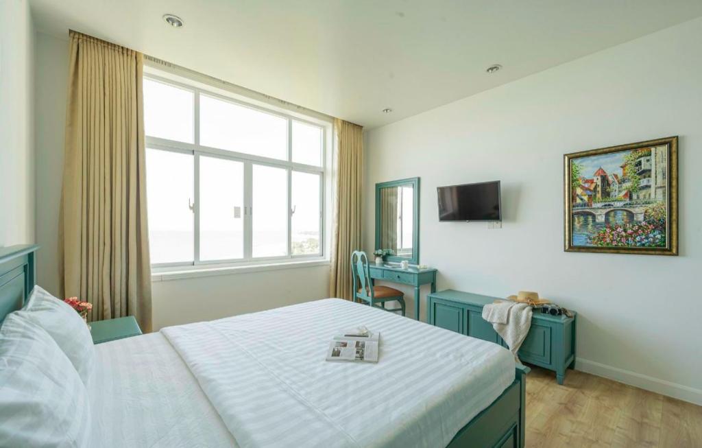 Giường trong phòng chung tại Ocean View Phan Thiết - Ocean Vista &amp; SeaLink Mũi Né
