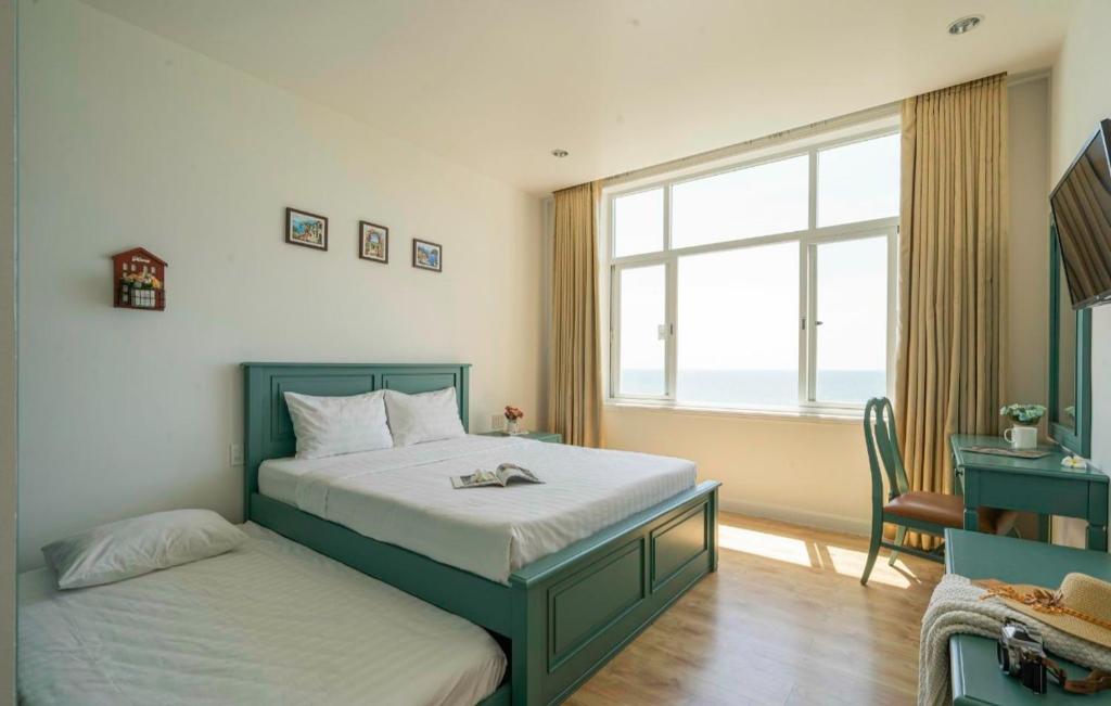 Giường trong phòng chung tại Ocean View Phan Thiết - Ocean Vista &amp; SeaLink Mũi Né