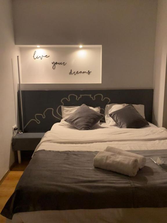 a bed with a black headboard with words above it at D&D SUİTES in Istanbul