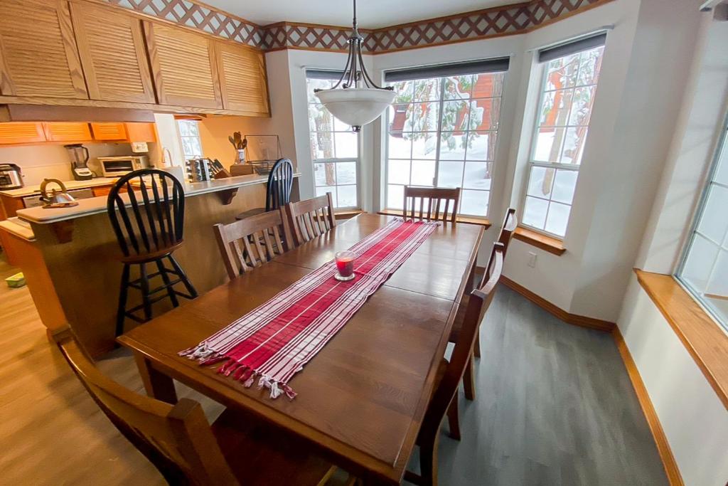 a kitchen and dining room with a wooden table at Blue Skies & Bay Bliss in Carnelian Bay