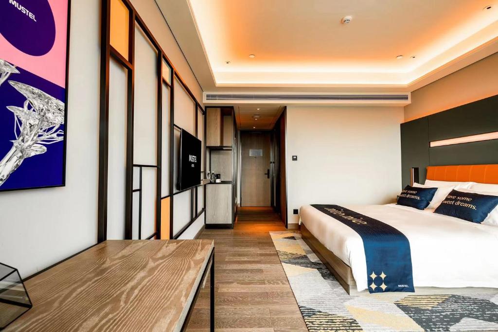 Postel nebo postele na pokoji v ubytování Mustel Hotel Knowledge City Guangzhou