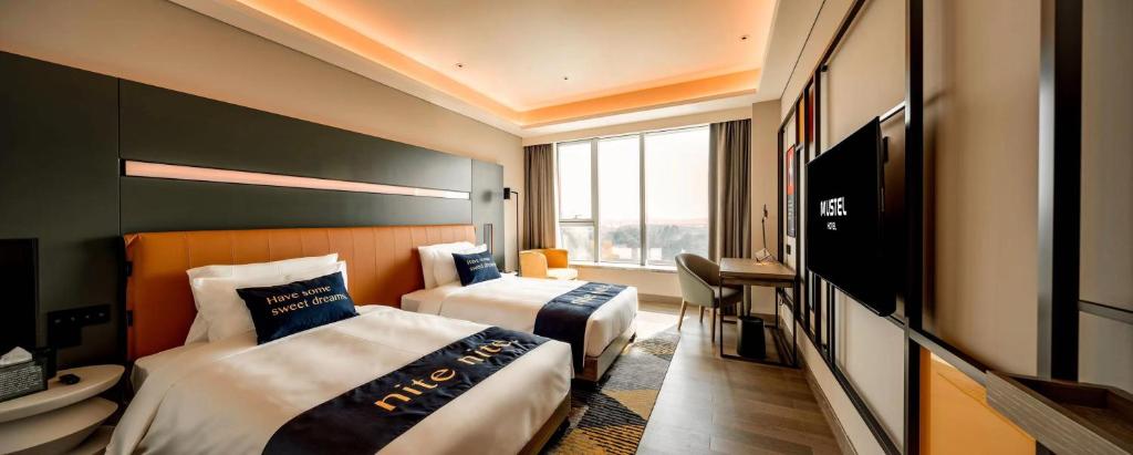 Postel nebo postele na pokoji v ubytování Mustel Hotel Knowledge City Guangzhou