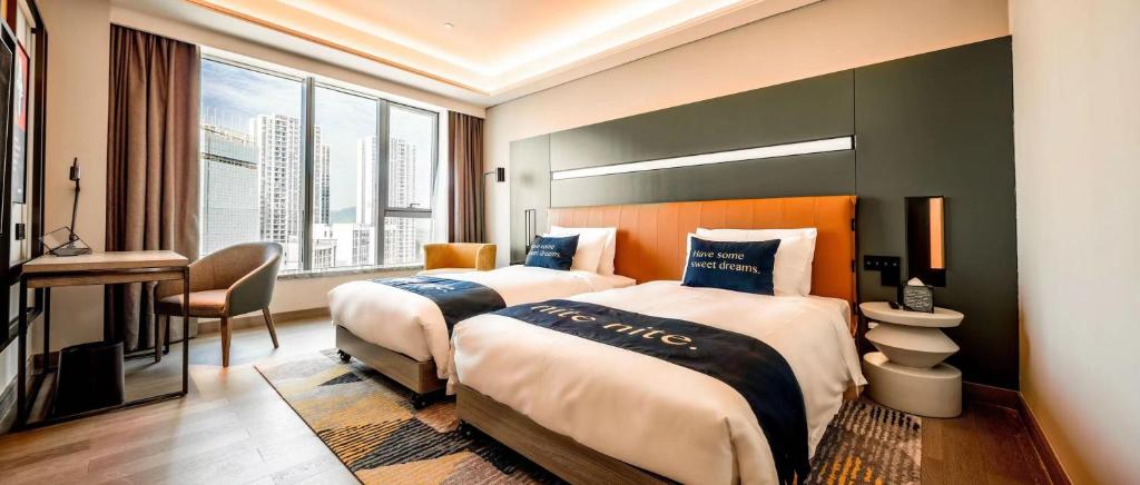 Postel nebo postele na pokoji v ubytování Mustel Hotel Knowledge City Guangzhou