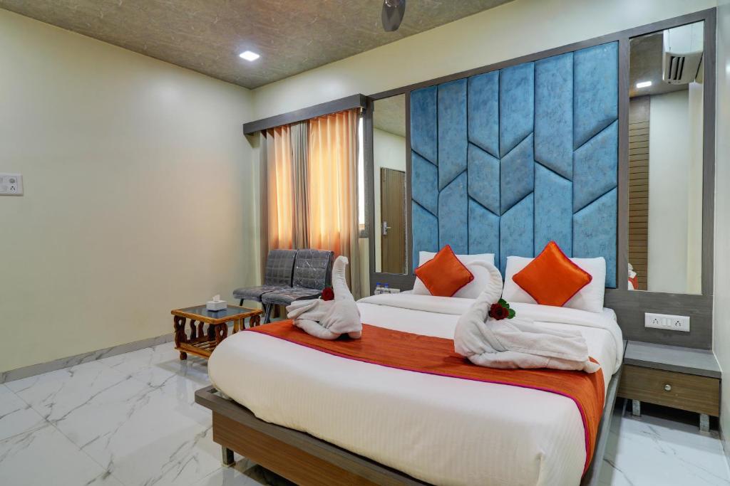 two beds in a hotel room with towels at Hotel Shree Residency Lodging & Boarding in Navi Mumbai