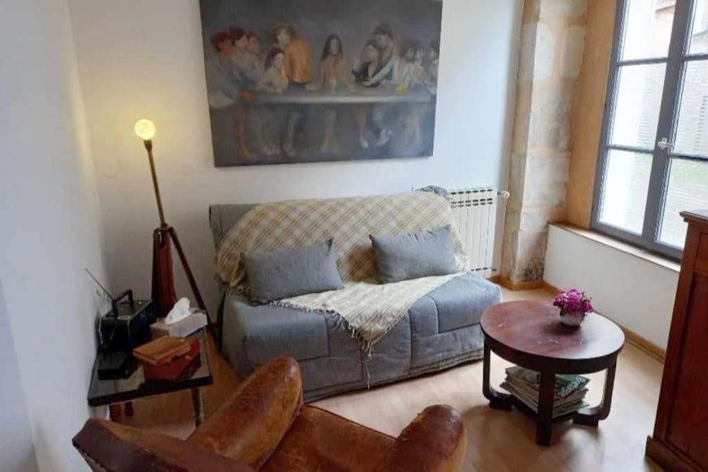 a living room with a couch and a table at La Loupière in Avallon