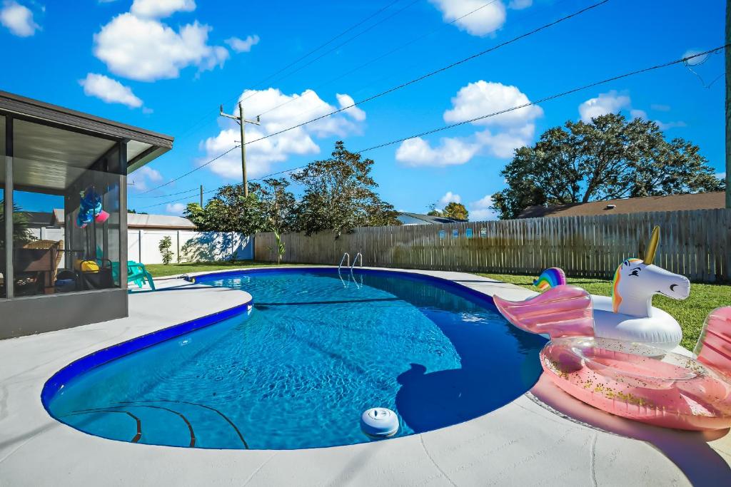 a small swimming pool in a backyard with a toy at Ixora16 Heated Pool, mins to beach, airport, USSSA, Cruise Port, 1h to Disney in Melbourne