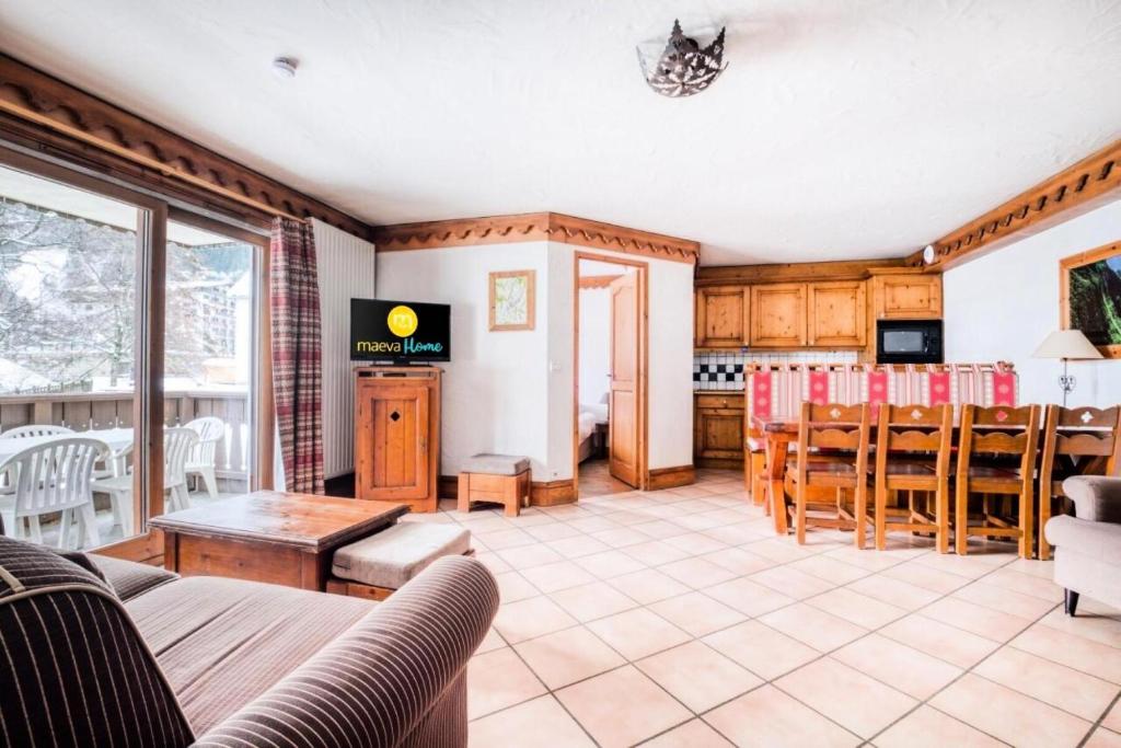 un salon avec un canapé et une table dans l'établissement Résidence La Ginabelle - maeva Home - Appartement 4 Pièces 8 Personnes - Sélection MAE-7444, à Chamonix-Mont-Blanc