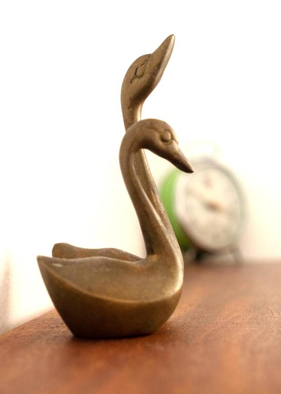 a small bronze statue of a duck sitting on a table at Vejerísimo Casa Boutique in Vejer de la Frontera