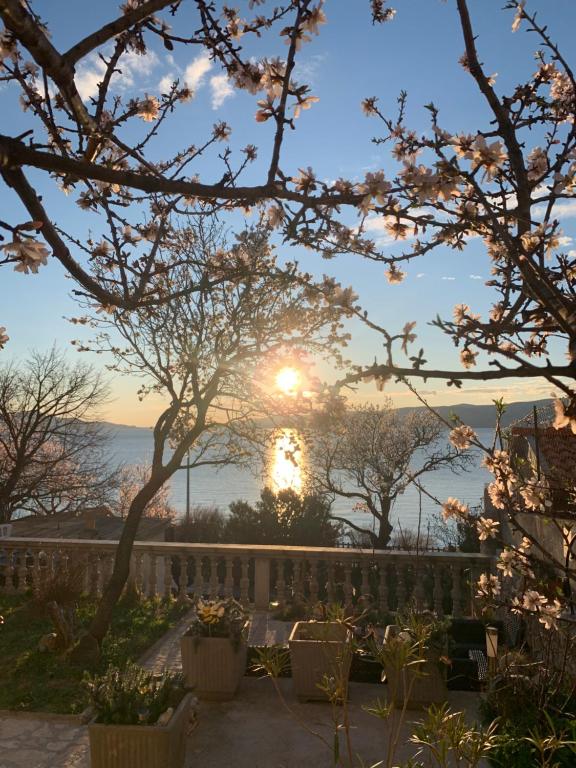 a view of the sunset from a garden with trees at Apartment Marino in Senj