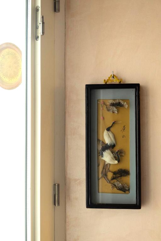 a framed picture of a bird on a wall at Vejerísimo Casa Boutique in Vejer de la Frontera