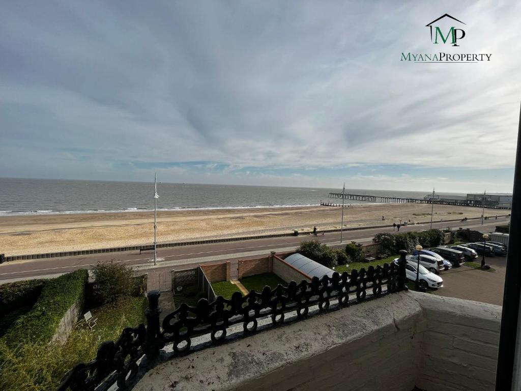 a view of the beach and the ocean from a balcony at Luxury Penthouse Apartment in Lowestoft