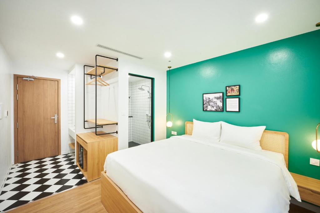 Postel nebo postele na pokoji v ubytování Wilque Hotel Hanoi