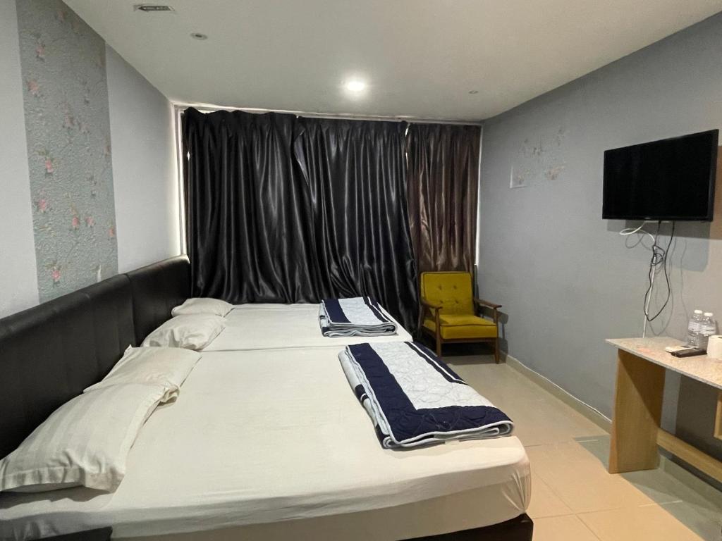 Postel nebo postele na pokoji v ubytování Hotel Rim Global Subang