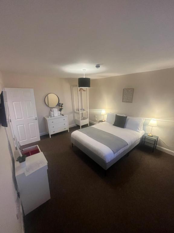 a bedroom with a large bed and two lamps at Church View Apartment in Great Yarmouth
