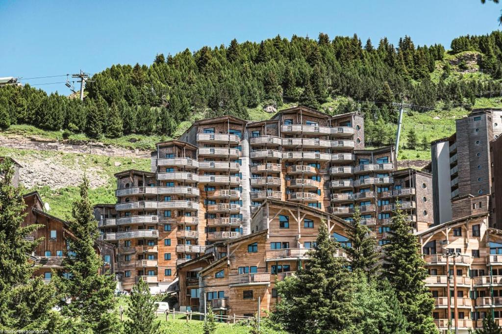 a large apartment building on the side of a mountain at Résidence Arietis - Atria-Crozats - maeva Home - Appartement 3 pièces 7 pe 914 in Morzine