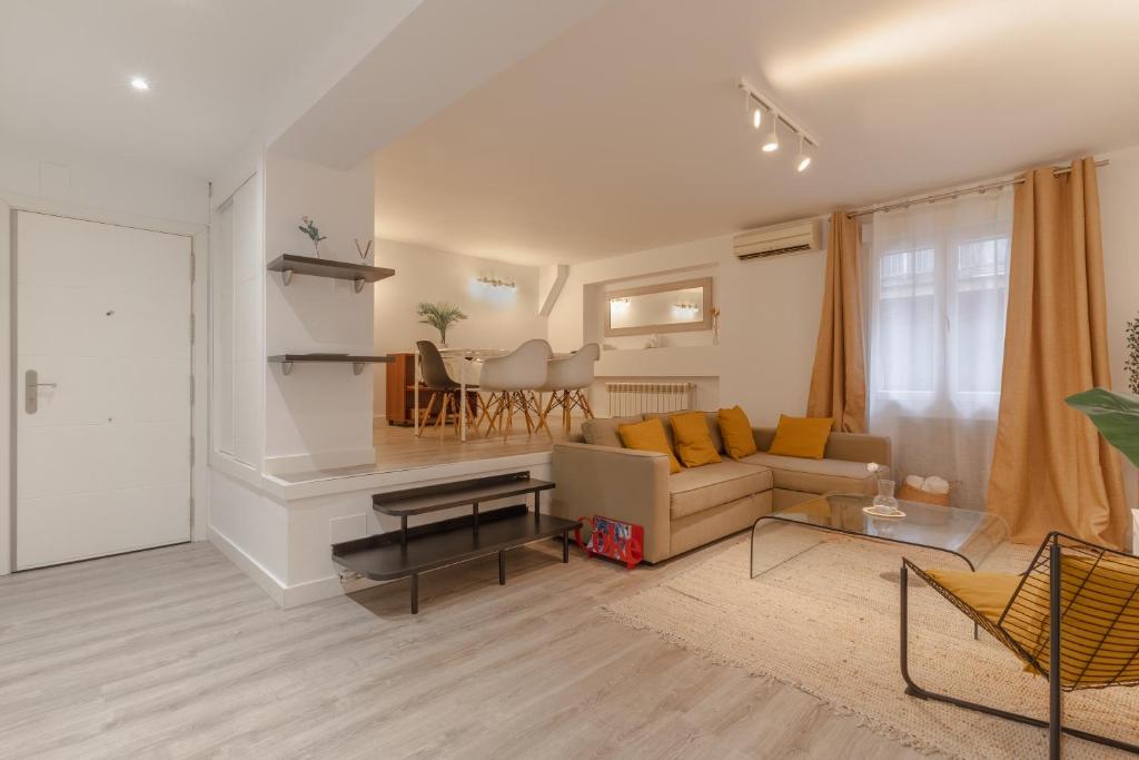 a living room with a couch and a table at Spacious modern-2Bedroom 2Bathroom-Bernabéu in Madrid