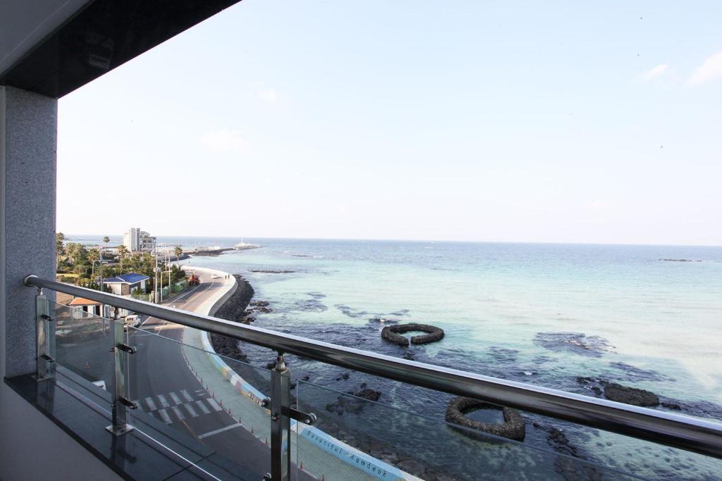 a view of the ocean from a balcony at Poem House in Jeju