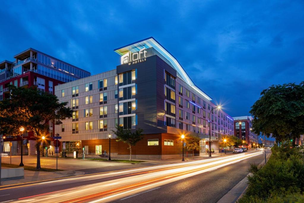 a building on a city street at night at Aloft by Marriott Minneapolis in Minneapolis