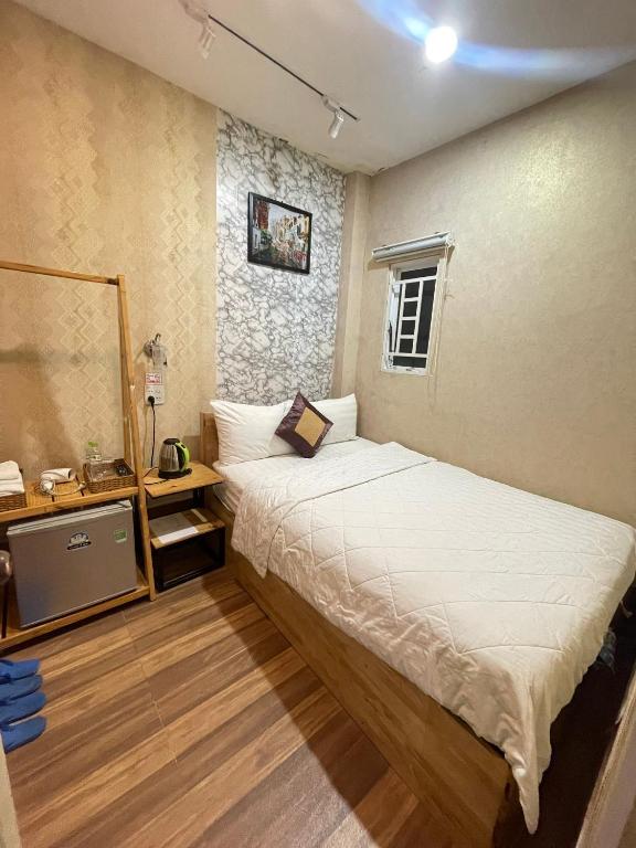 Postel nebo postele na pokoji v ubytování Winny Hotel Ninh Kieu Quay