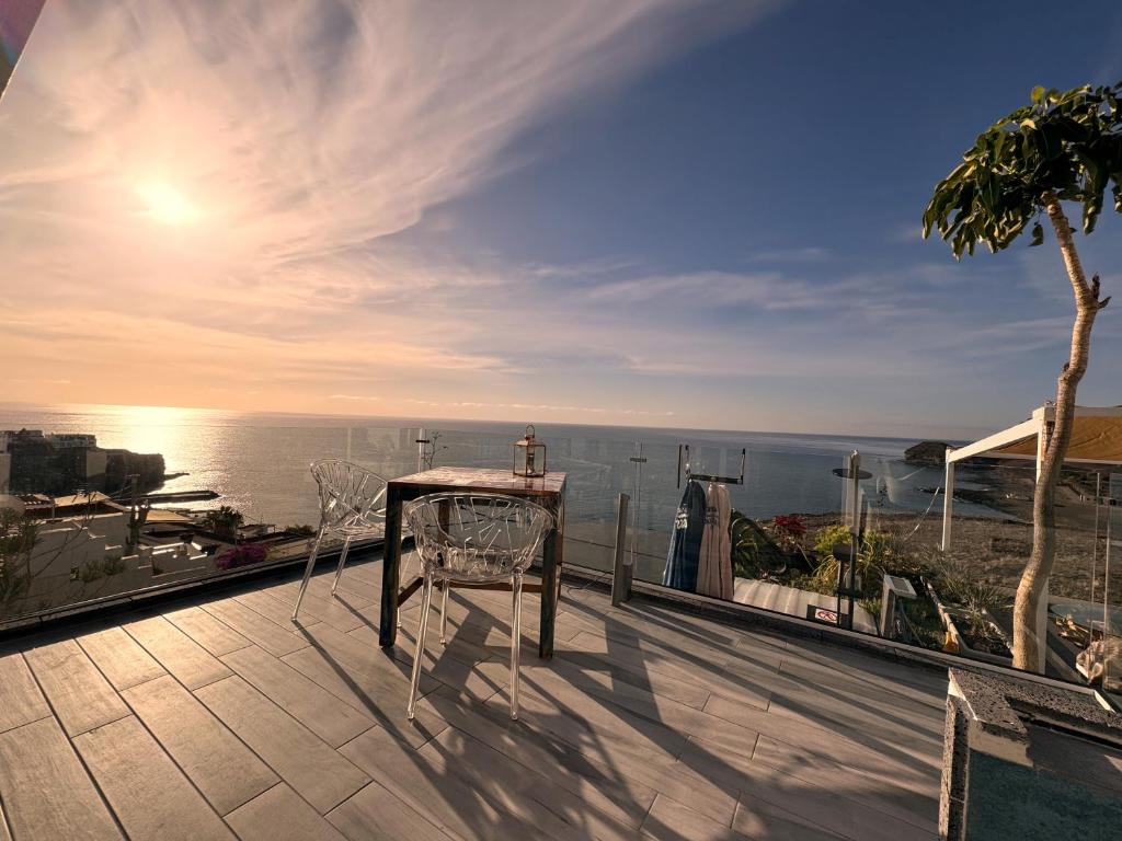 balcón con mesa y vistas al océano en El Ático Bonito, en Las Playitas