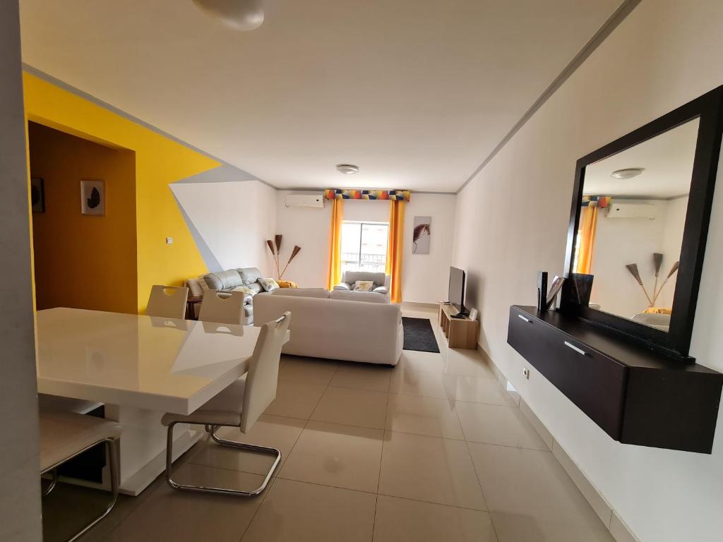 a living room with a couch and a television at Remarkable 3-Bed Apartment in Kilamba - Luanda in Luanda