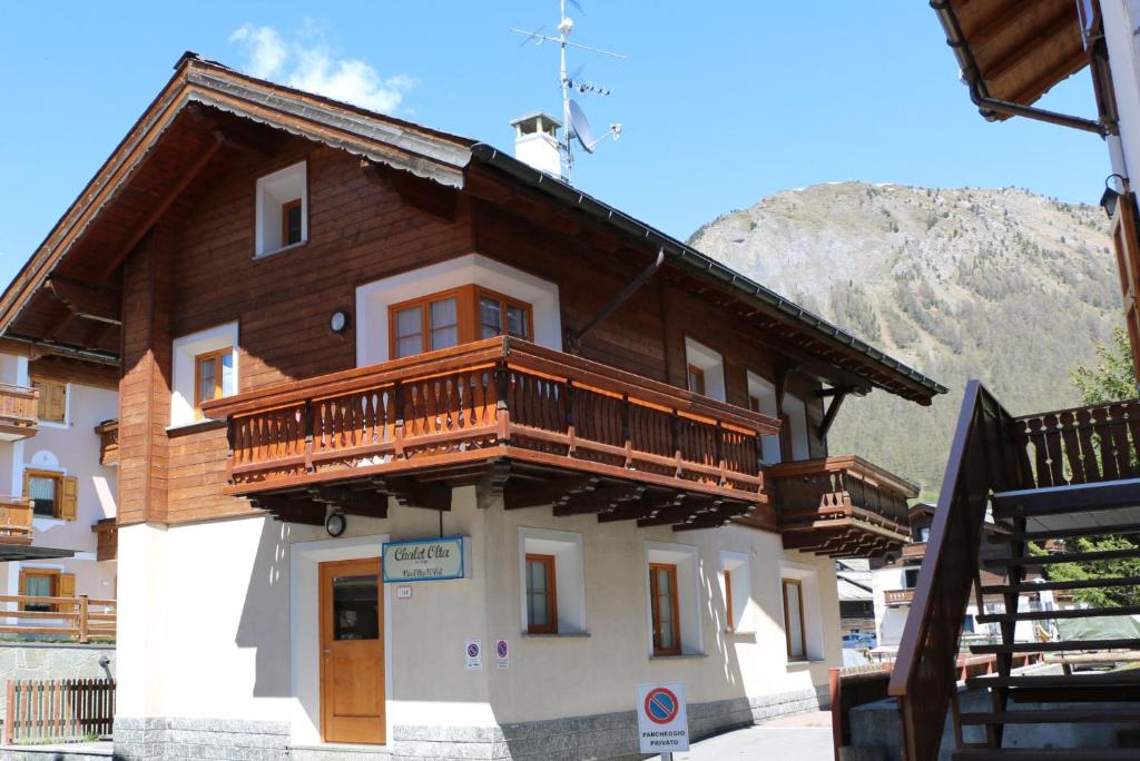 a building with wooden balconies on top of it at Chalet Olta in Livigno