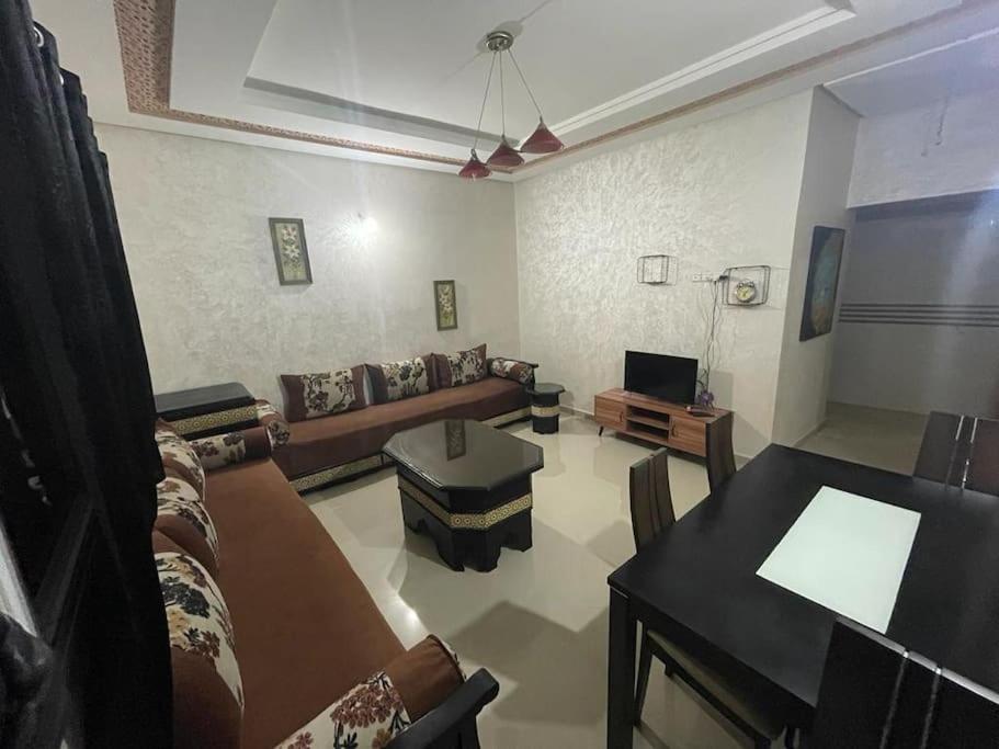 a living room with a couch and a table at E Nice one bedroom apartement wifi in Fez