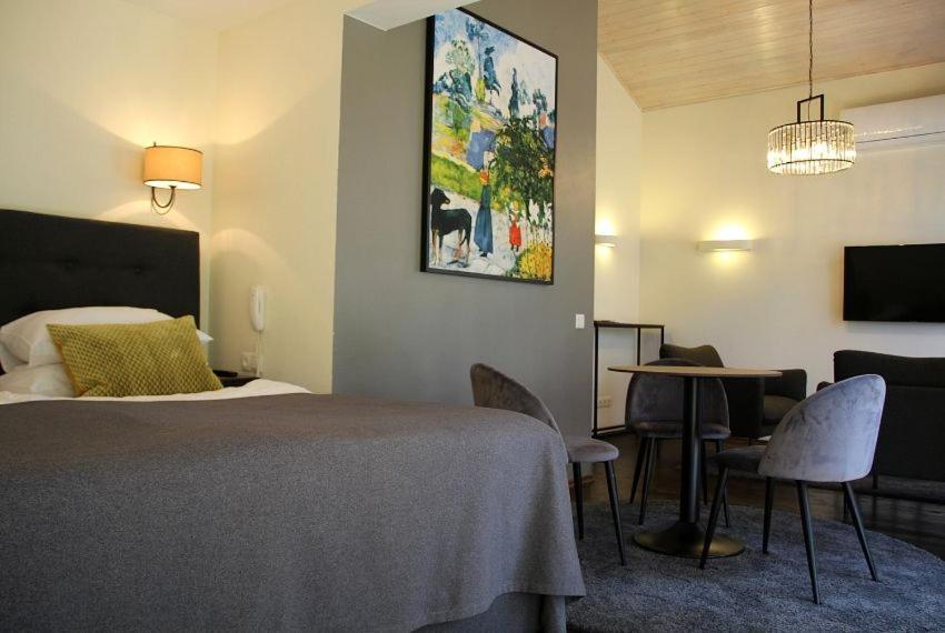 a hotel room with a bed and a table and chairs at Margis Hotel & SPA in Trakai