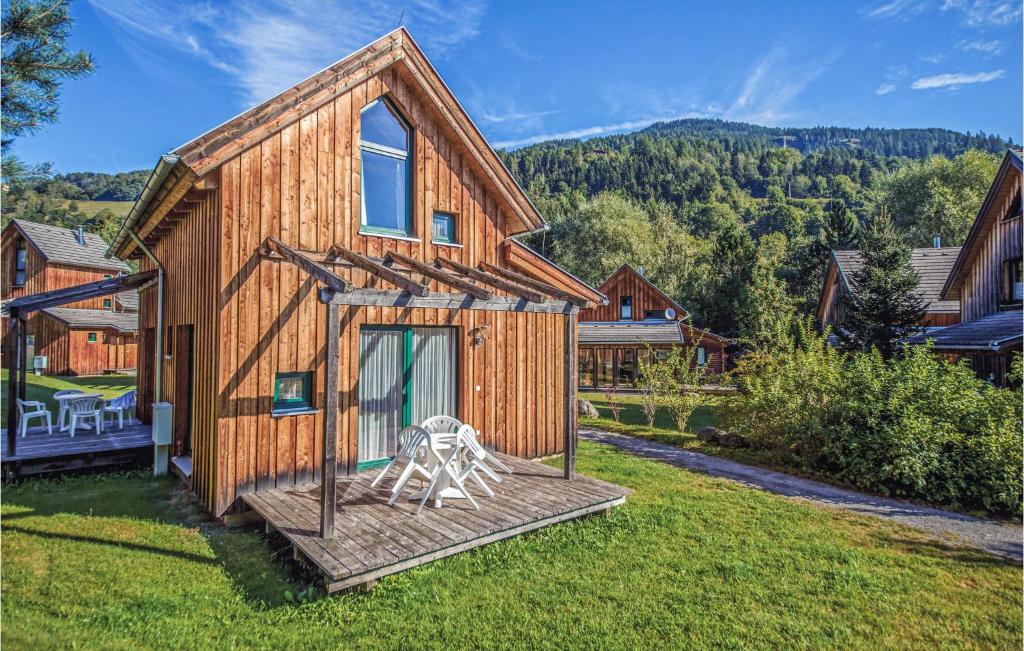a wooden house with a statue in front of it at Awesome Home In St,georgen A,kreischb, With 1 Bedrooms, Internet And Indoor Swimming Pool in Sankt Lorenzen ob Murau