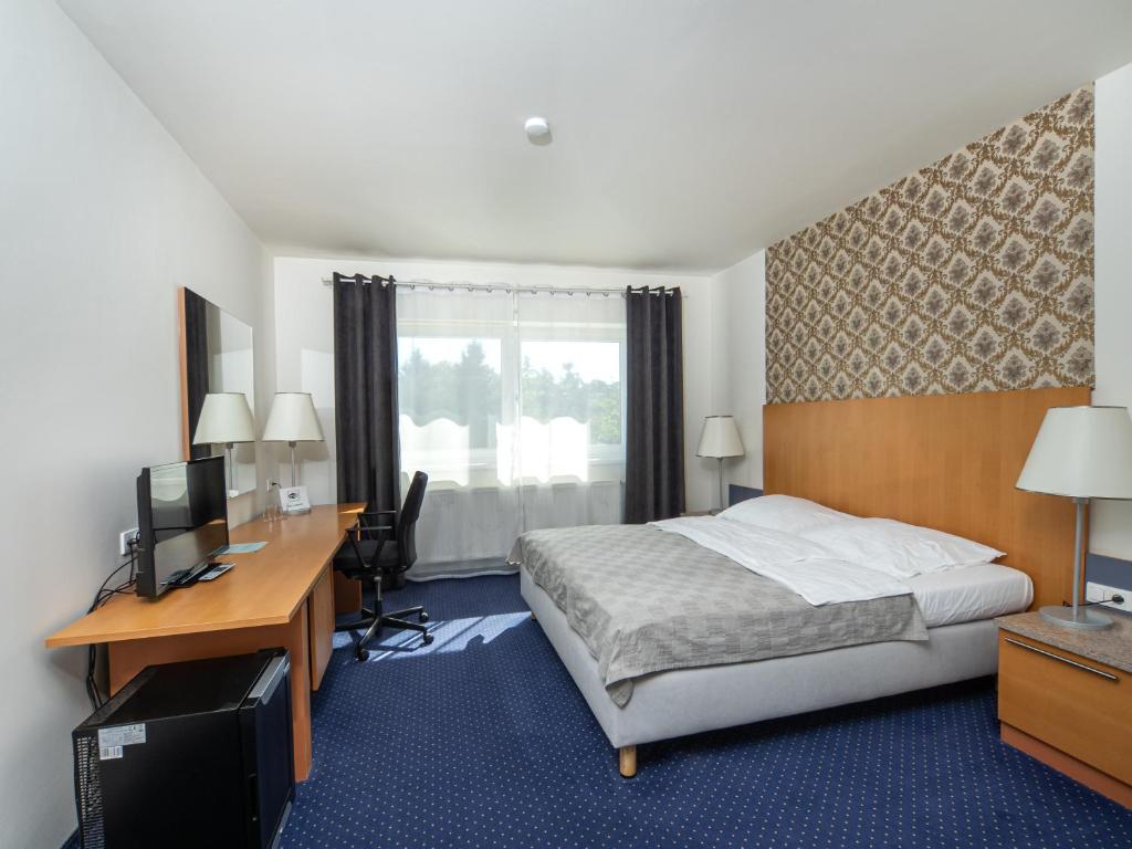 Postel nebo postele na pokoji v ubytování Hotel Dvůr