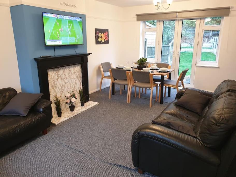 a living room with a couch and a table and a television at Perry House in Nottingham