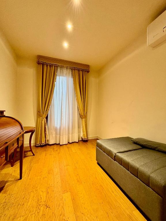 a bedroom with a bed and a large window at Locanda del Ghetto in Venice