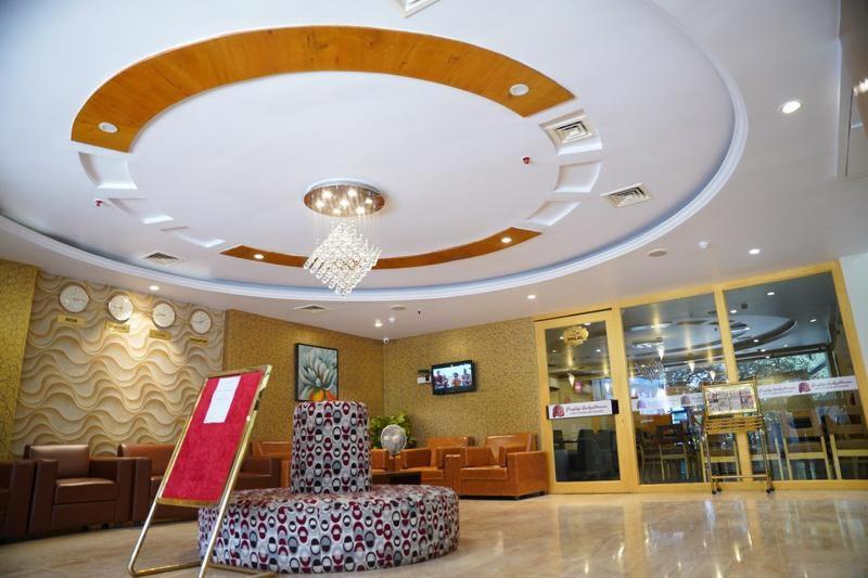 a lobby with a chair in the middle of a building at The Road View Grand Hotel & Multi Cuisine Restaurant- 18 Percentage Off On Food Order- An Svm Brand in Hyderabad