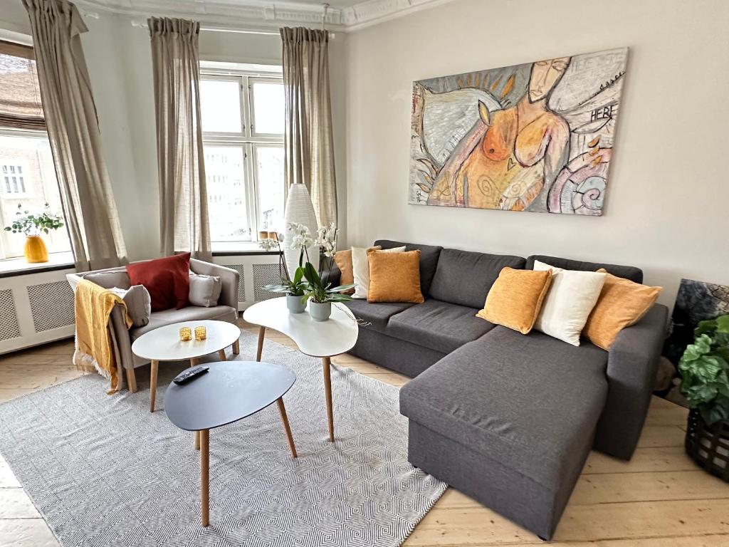 a living room with a couch and a table at Boutique-Aalborg-Free parking - Citycenter in Aalborg